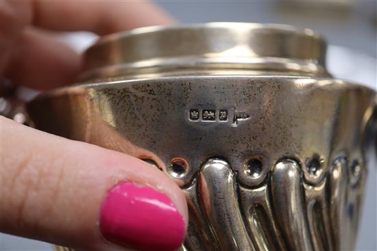 An Edwardian silver tea caddy, Walker & Hall, Sheffield, 1907, a later silver cigarette box and silver inkwell.